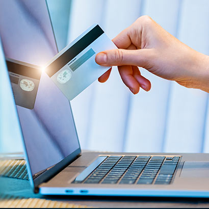 credit card reflecting off of a laptop screen