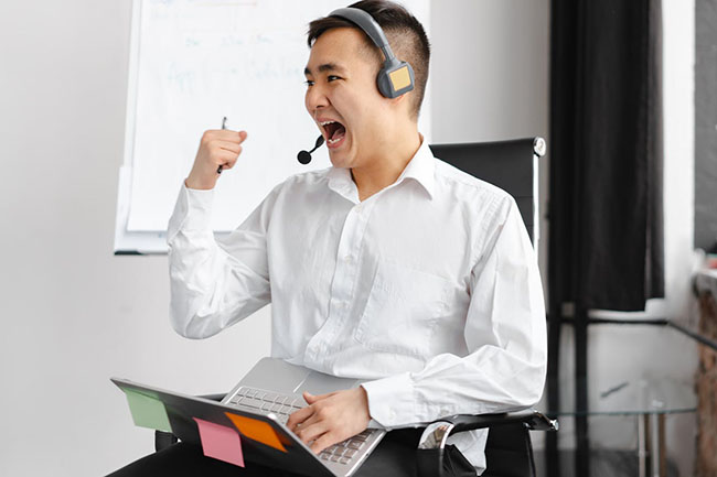 happy businessman wearing headset in office