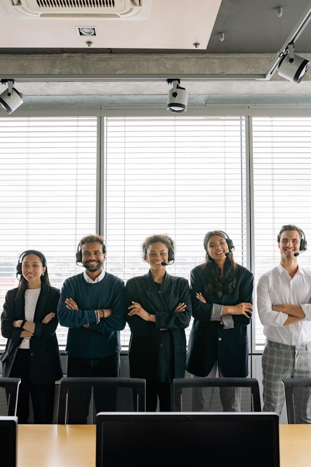 office workers standing in a line wearing headsets