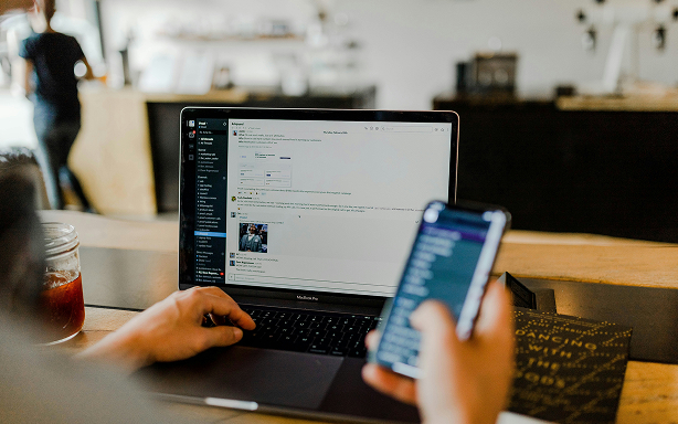 scrolling on phone with desktop in office